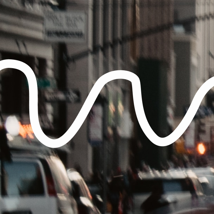 Blurred image of a busy street with scribble graphic overlay