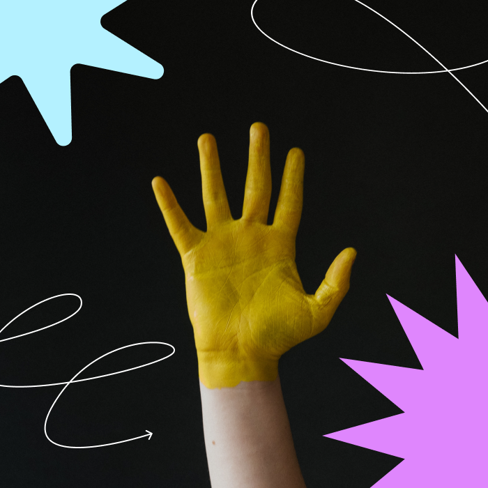 Image of a yellow hand with starburst and scribble illustrations